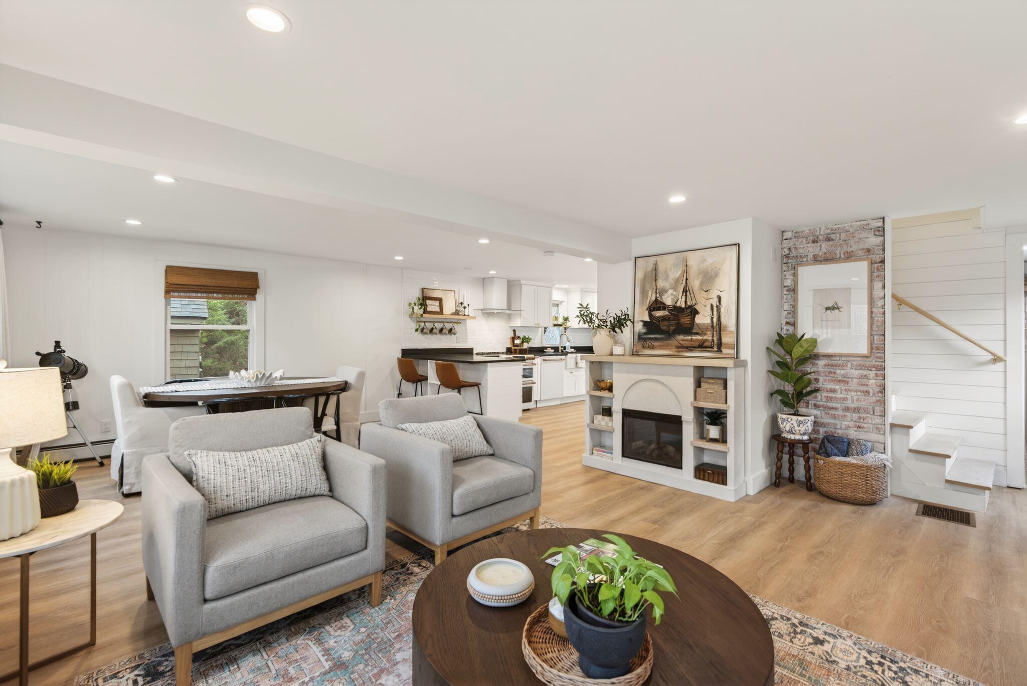 Open-plan living room, dining, and kitchen — full staging