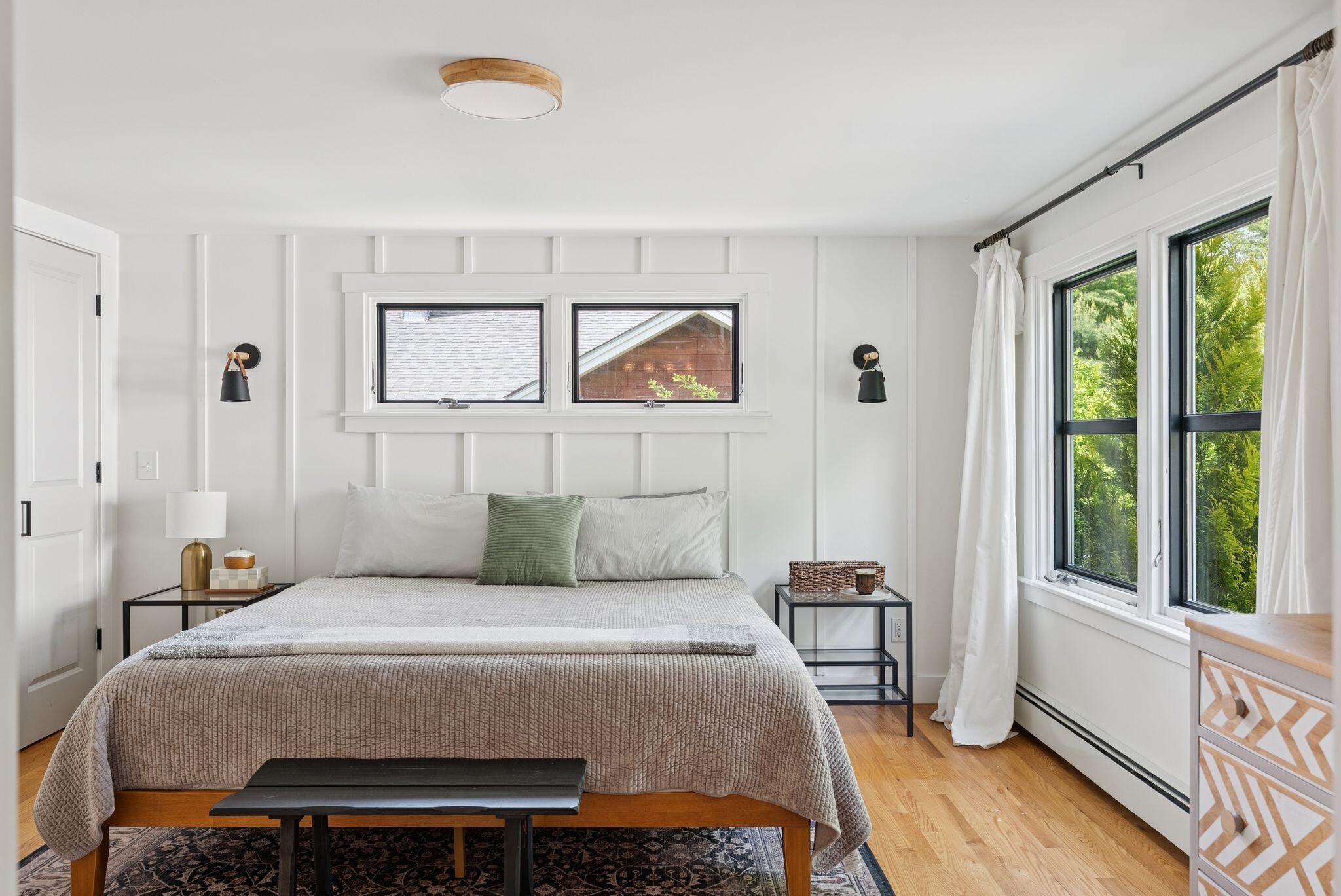 Staged bedroom with board and batten wall and linen bedding
